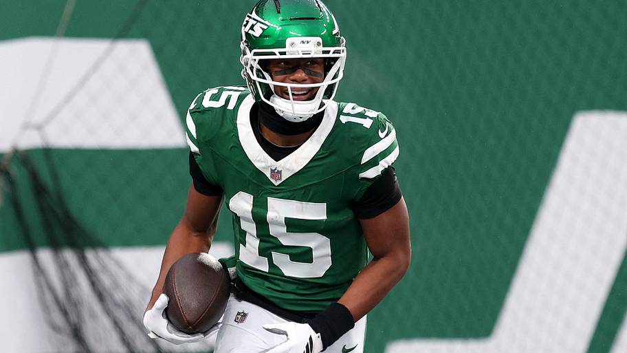 Adonai Mitchell holds the ball.
