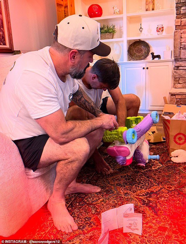 The 42-year-old NFL star was seen tinkering with children's toys for Luke's two children