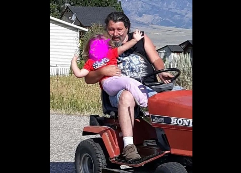 Lance Talbot gives 10-year-old Stelmaria a ride on a lawn mower. Talbot died July 13 from health problems and injuries he sustained in a July 2 house fire. | Courtesy photo