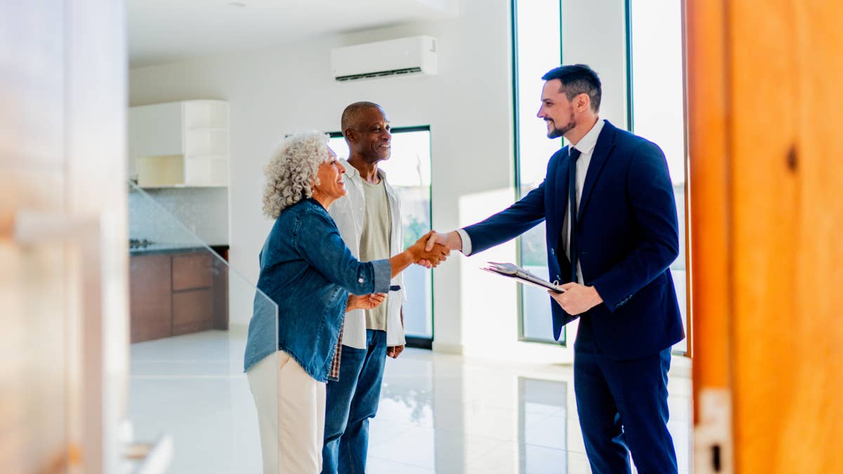 senior-couple-shaking-hands-with-realtor