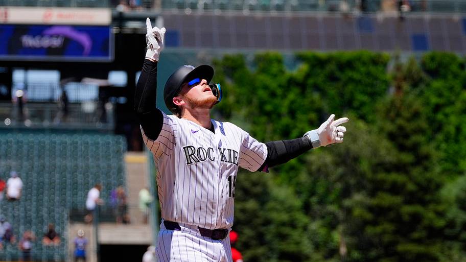 Colorado Rockies catcher Hunter Goodman celebrates by pointing his fingers in the air