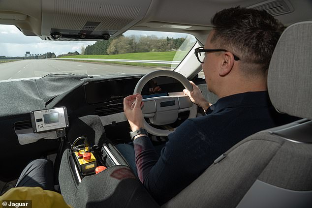 Daily Mail motoring editor Rob Hull pictured at the wheel of a Jaguar Type 01 prototype earlier this year. As you can see, the steering wheel design is very similar to that of Range Rover GT