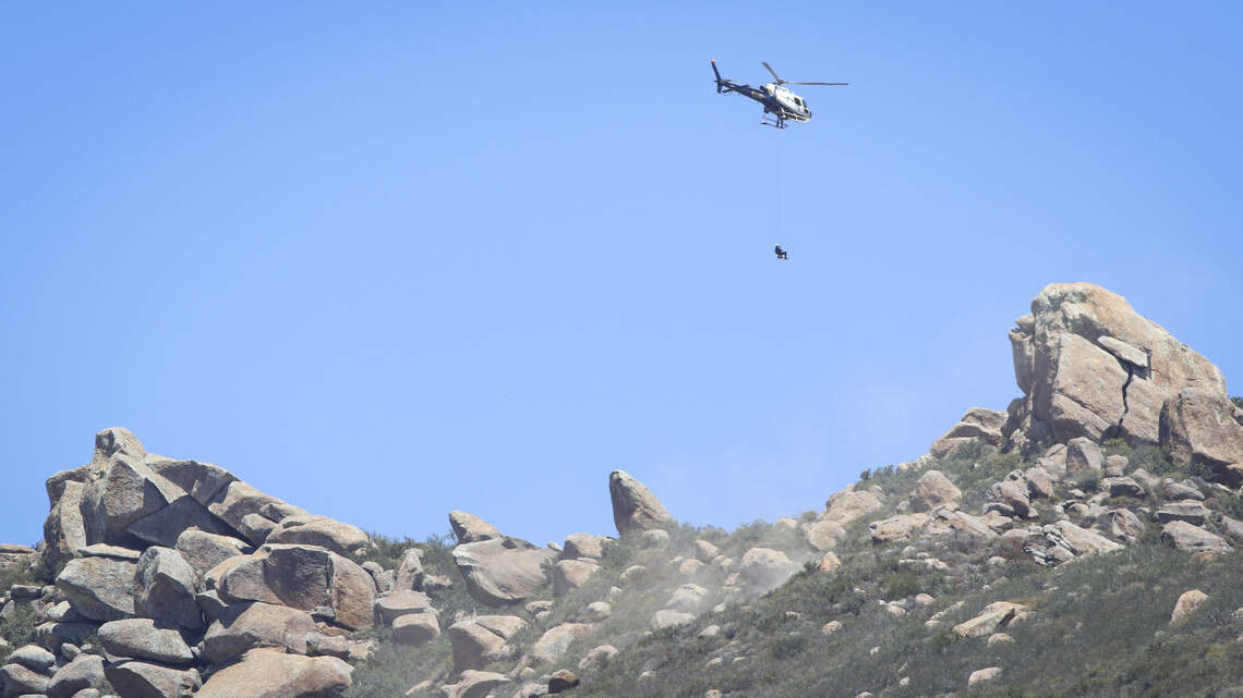 San Luis Obispo City Fire Capt. Dusty Renner is cable-hoisted down to the top of Bishop Peak to rescue a hiker in distress on July 21, 2026.