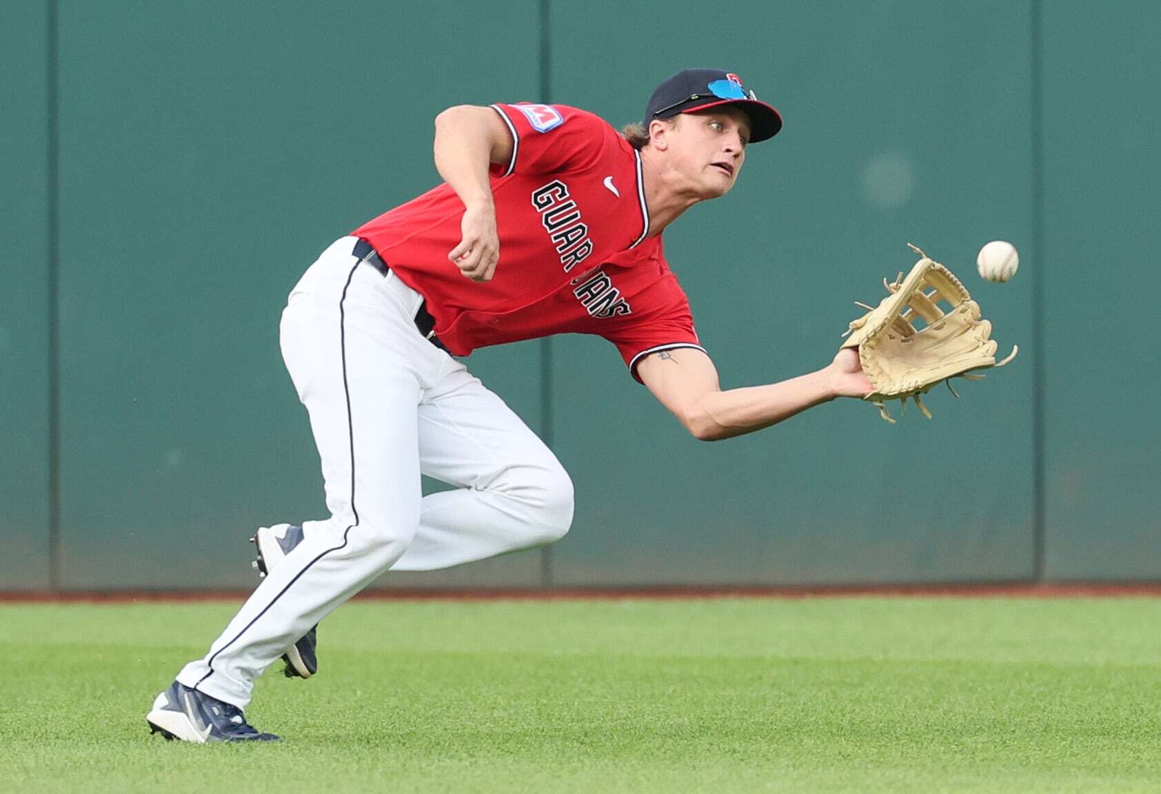 Cleveland Guardians center fielder Petey Halpin runs down a line drive for the out off the bat of Minnesota Twins shortstop Ryan Kreidler in the third inning.