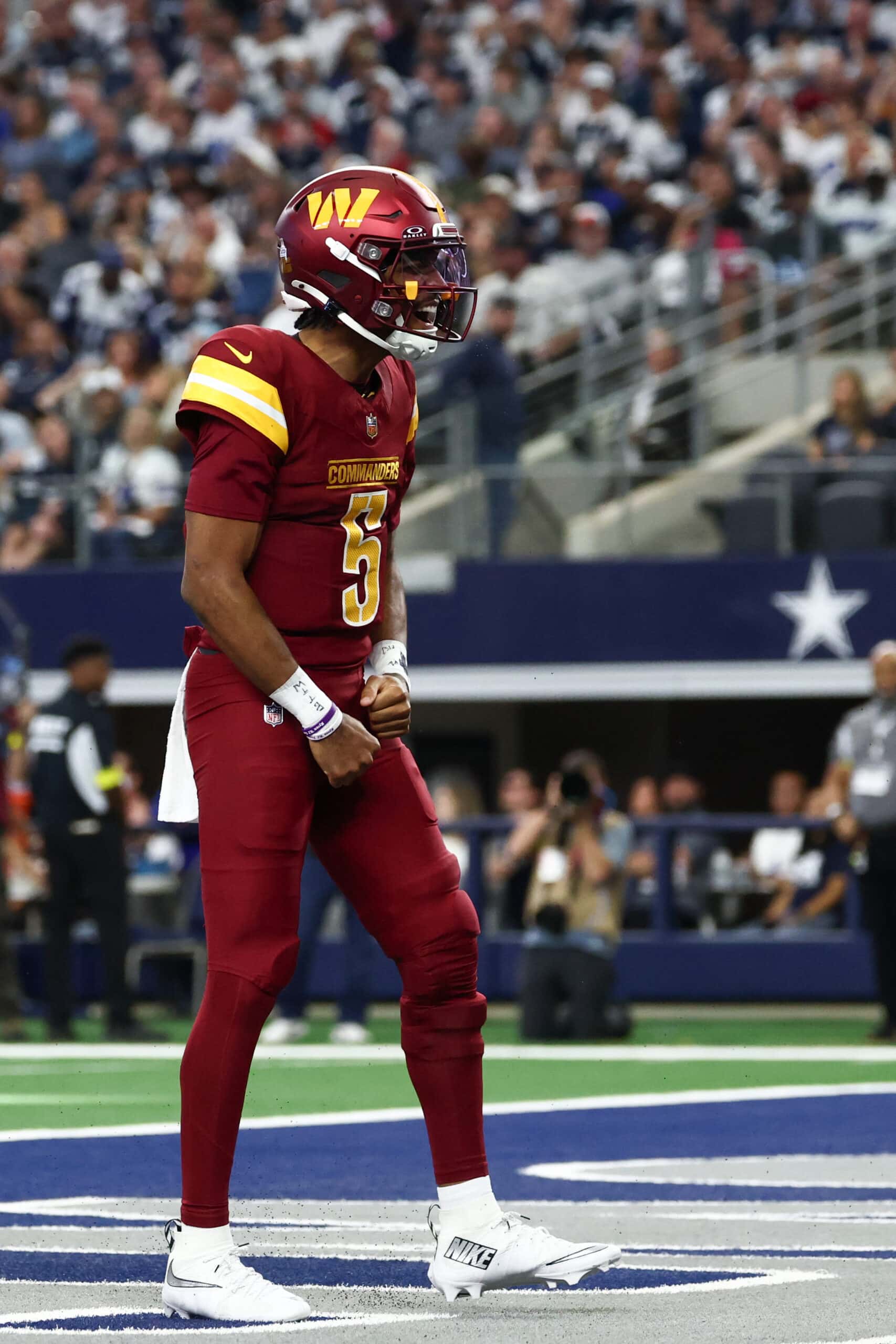 Oct 19, 2025; Arlington, Texas, USA; Washington Commanders quarterback Jayden Daniels (5) celebrates after scoring a touchdown against the Dallas Cowboys during the second quarter of the game at AT&T Stadium. Mandatory Credit: Kevin Jairaj-Imagn Images