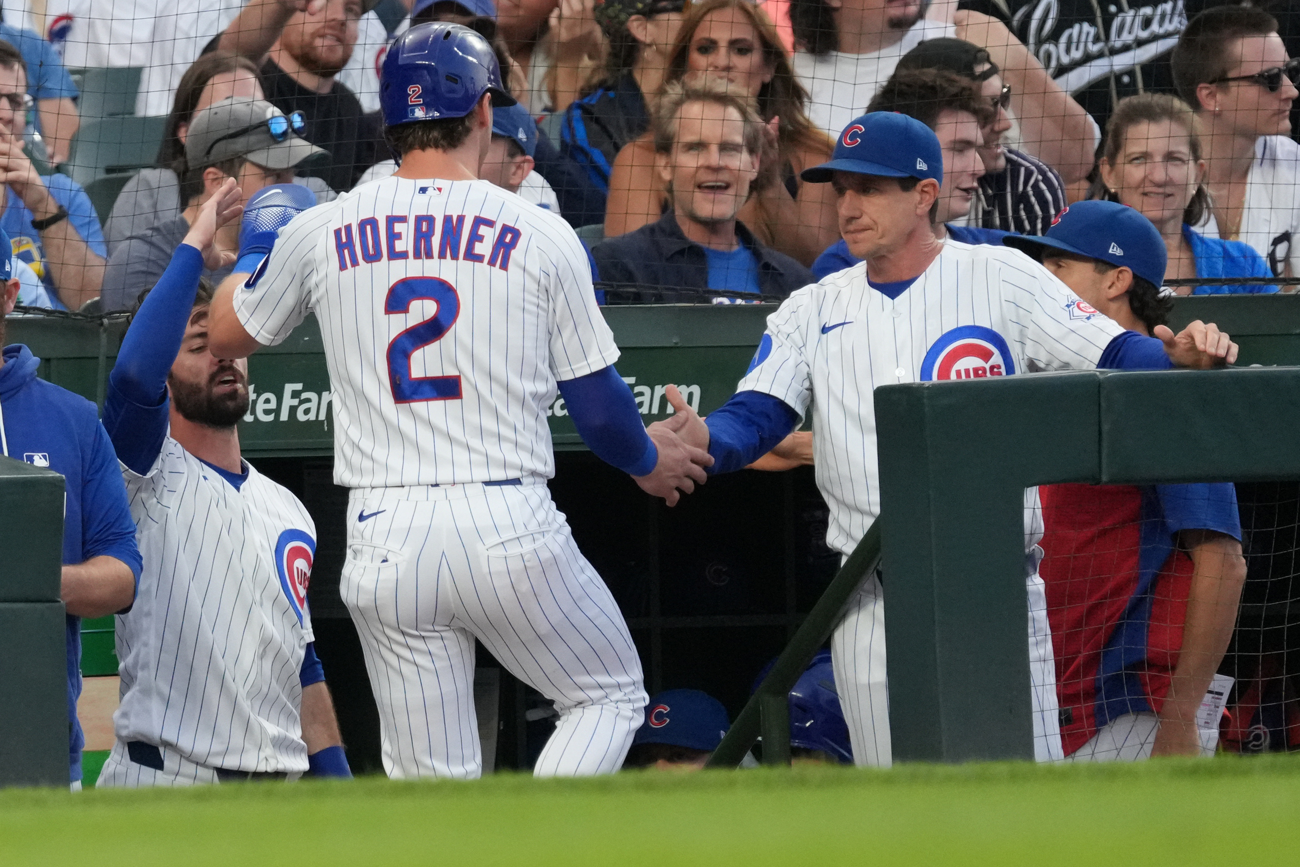 Chicago Cubs' Nico Hoerner (2) is greeted by manager Craig Counsell, right, after scoring against the Detroit Tigers during the first inning of a baseball game Tuesday, July 21, 2026, in Chicago. (AP Photo/David Banks)