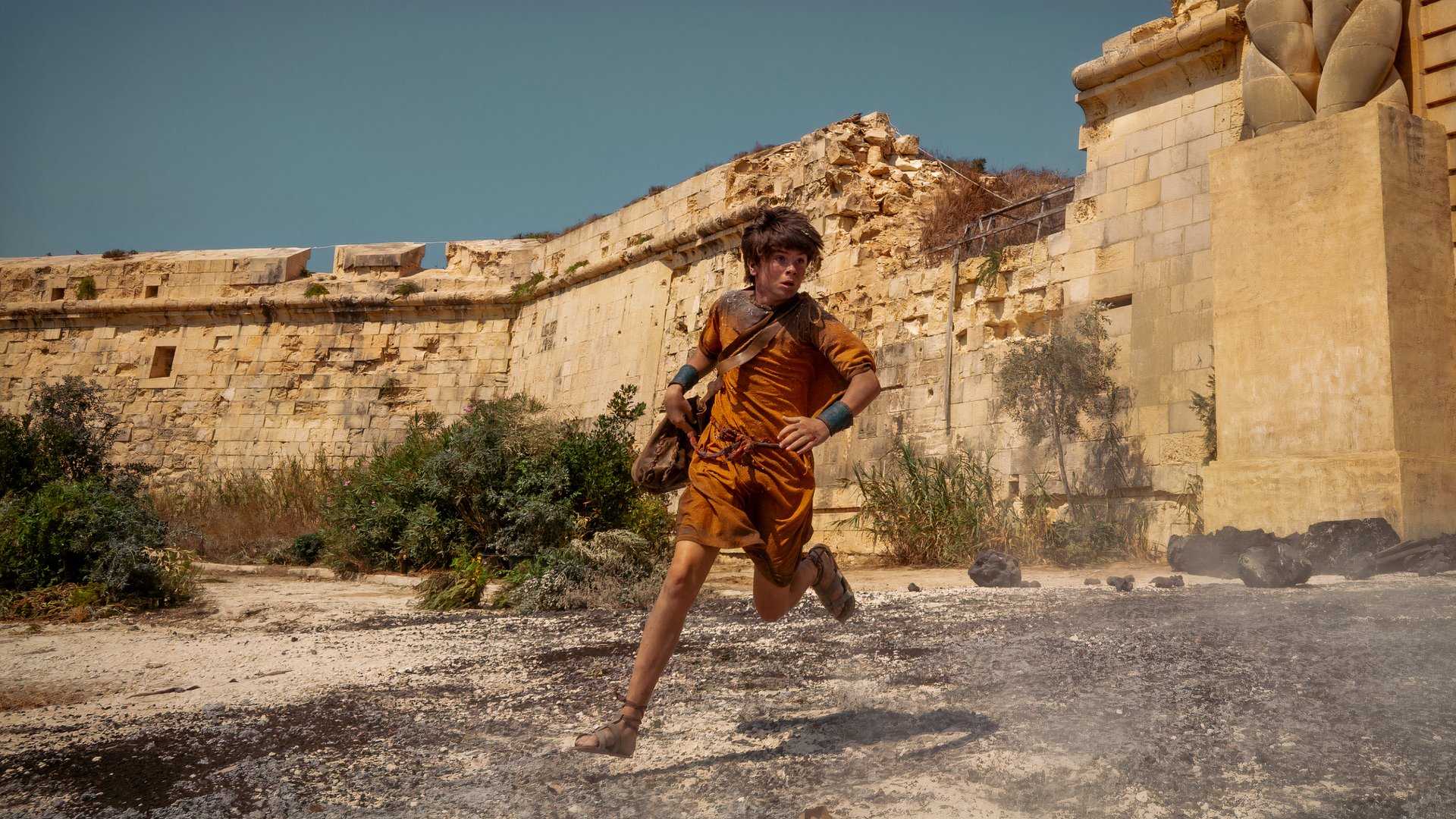 A boy runs in Pompeii Out of Time.