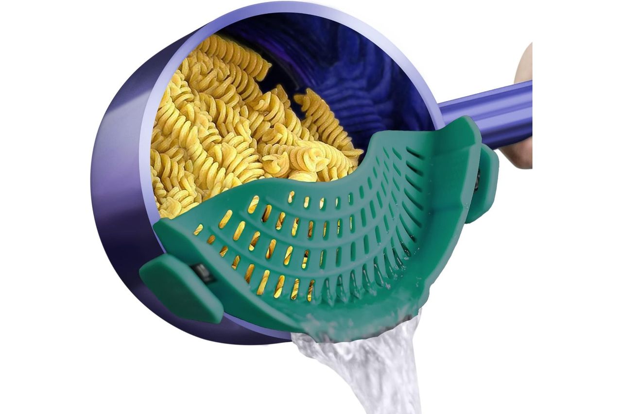 Clipon silicone strainer attached to a pot draining water while retaining pasta inside the pot