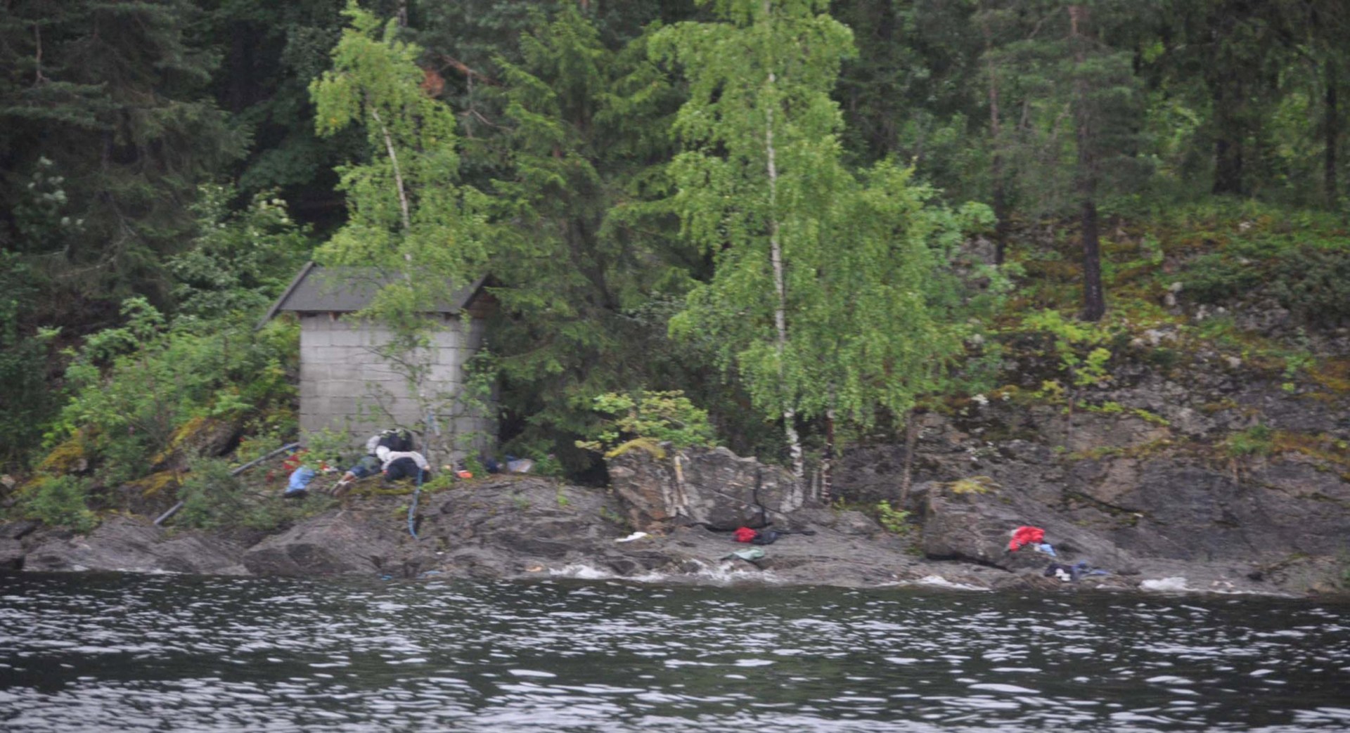 Victims lie on the banks following terror shootings at a summer youth camp on July 22, 2011 on Utoya Island, Norway.