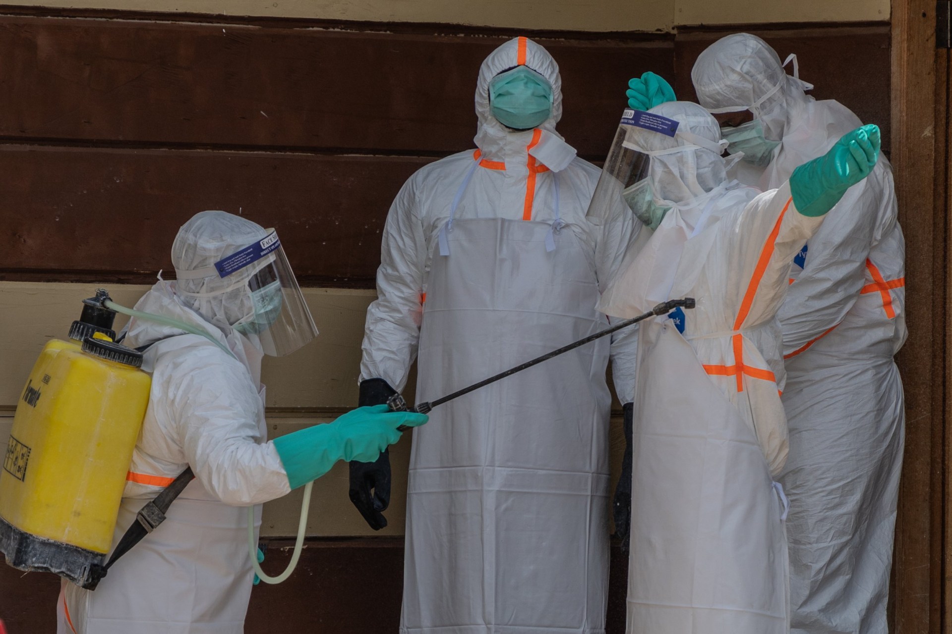 Health workers disinfect themselves after preparing the body of an Ebola victim at Citadelle Clinic in Bunia, Congo, Friday, June 12, 2026. (AP Photo/Moses Sawasawa)