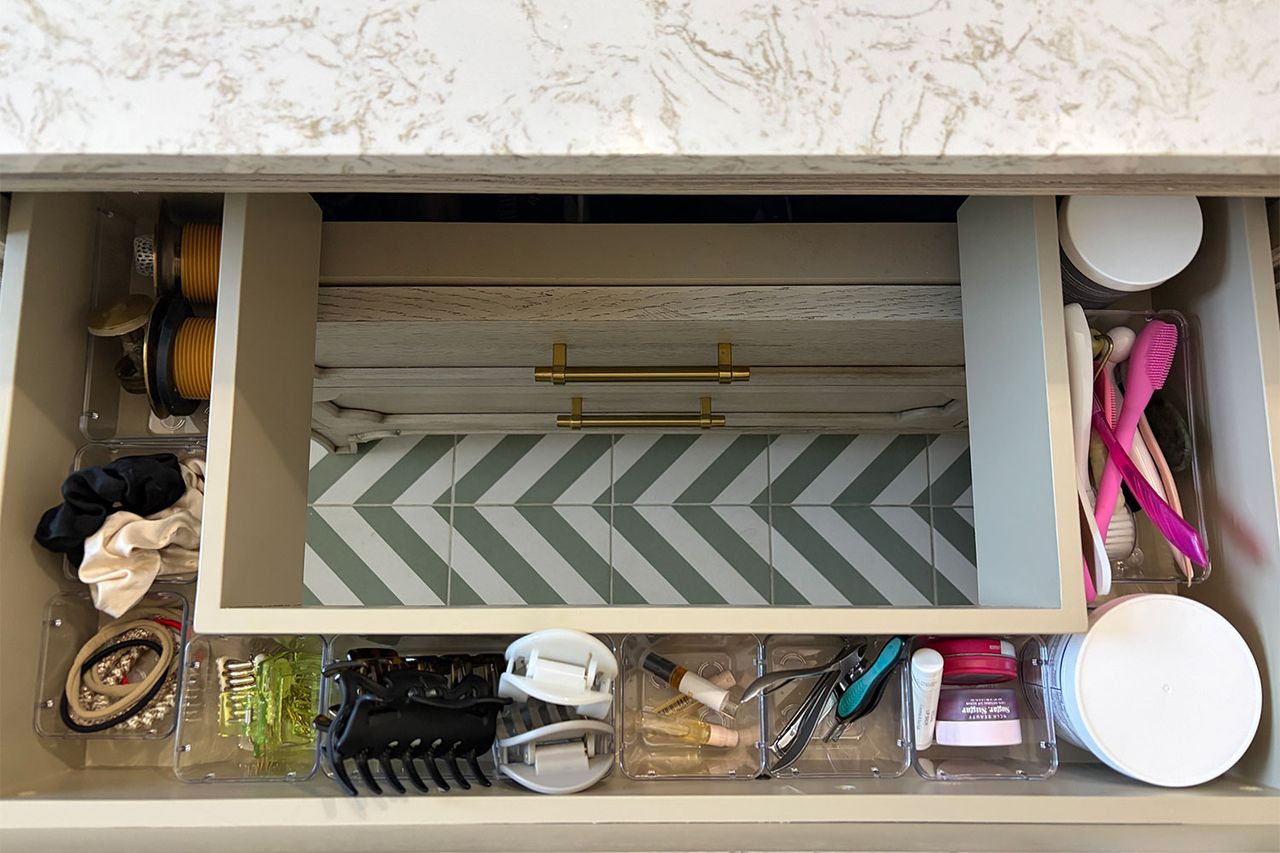 Drawer organized with containers holding various small items and personal care products