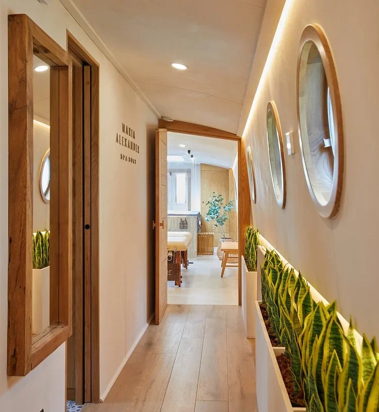 The corridor of the Maria Alexander spa boat, decorated in cream paint and warm wood.