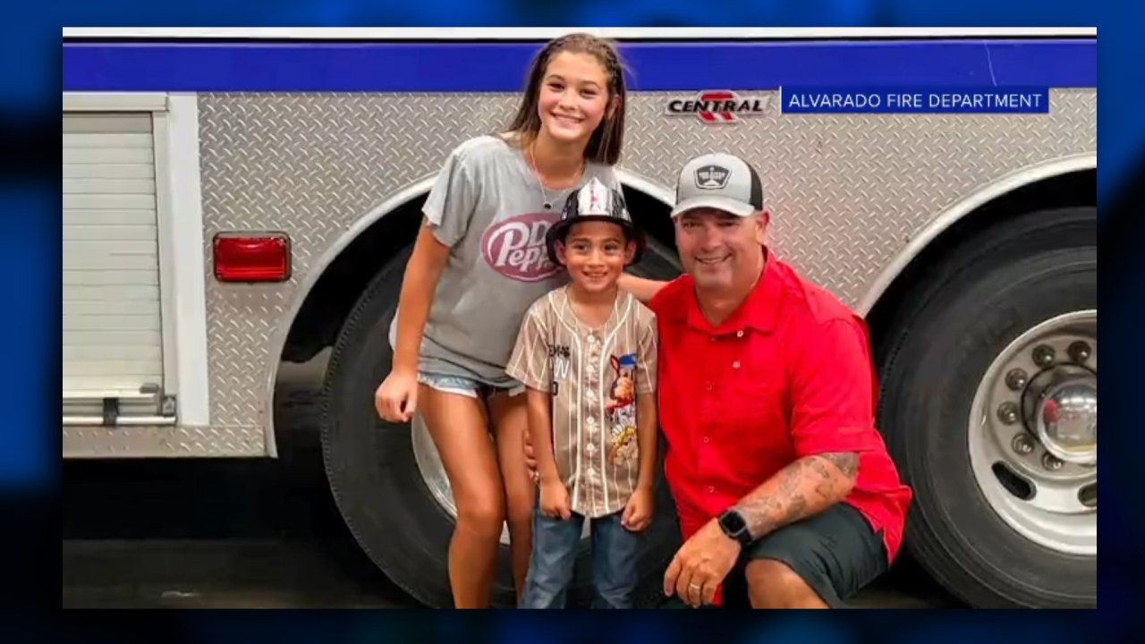 Firefighter and daughter with the little boy they helped save