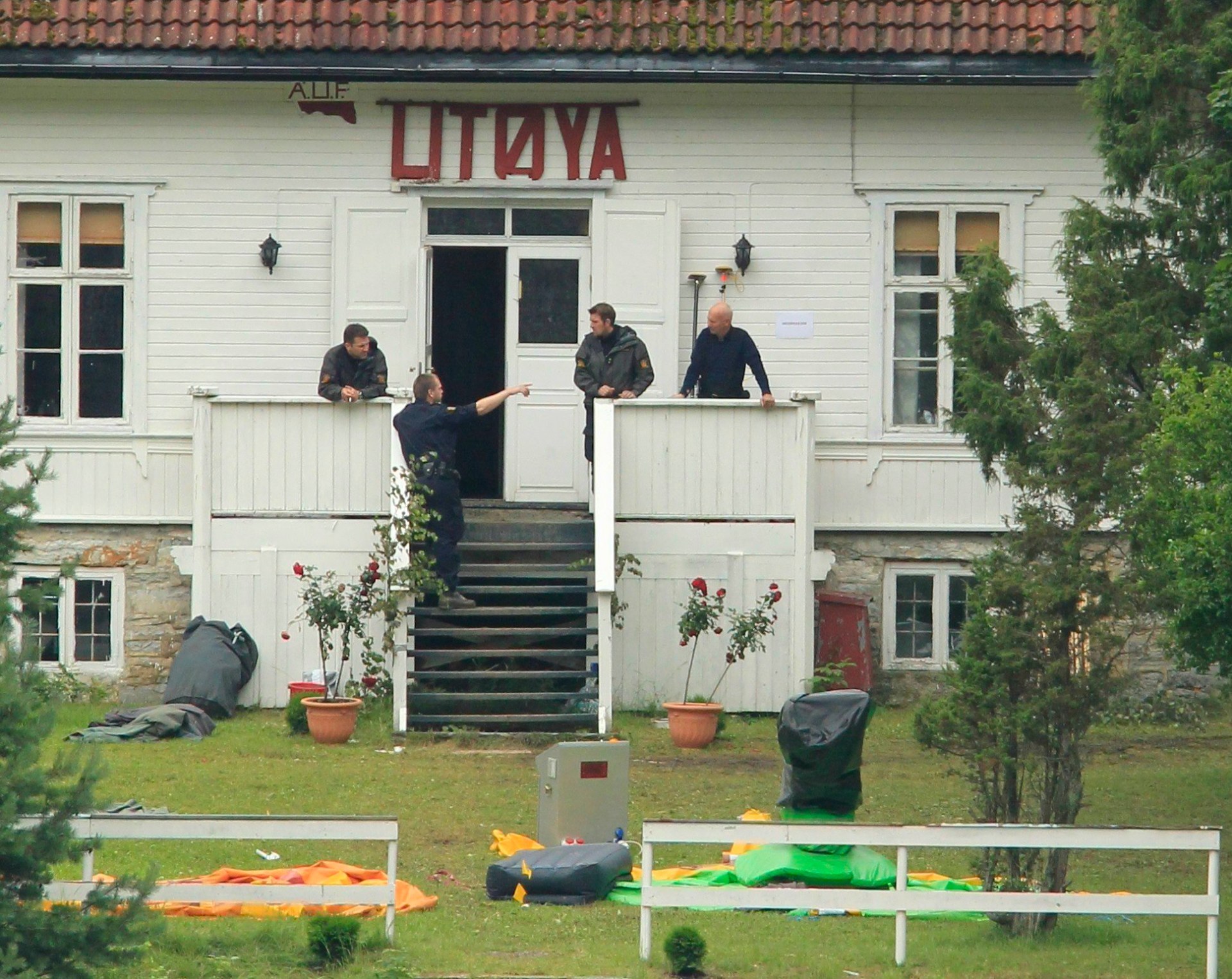 Police continue their investigations on the Utoeya islad outside the main school building.