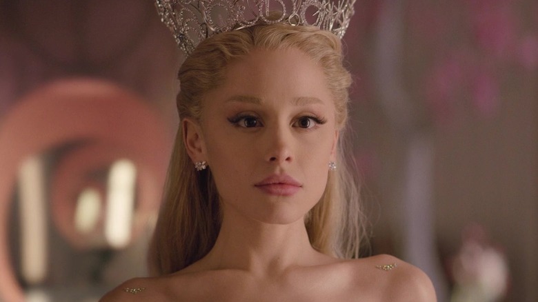 Glinda looking at herself in a mirror while wearing a tiara in Wicked: For Good