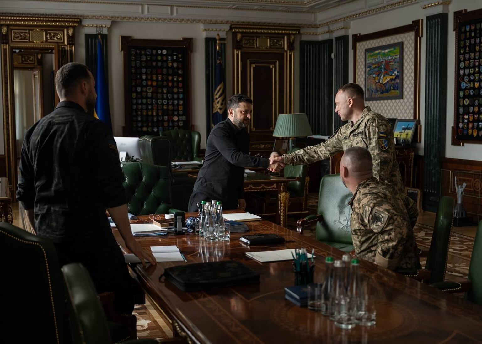 Ukrainian President Volodymyr Zelensky, centre, said Major General Mykhailo Drapatyi, centre right, must present an updated defence strategy (Ukrainian Presidential Press Office via AP)