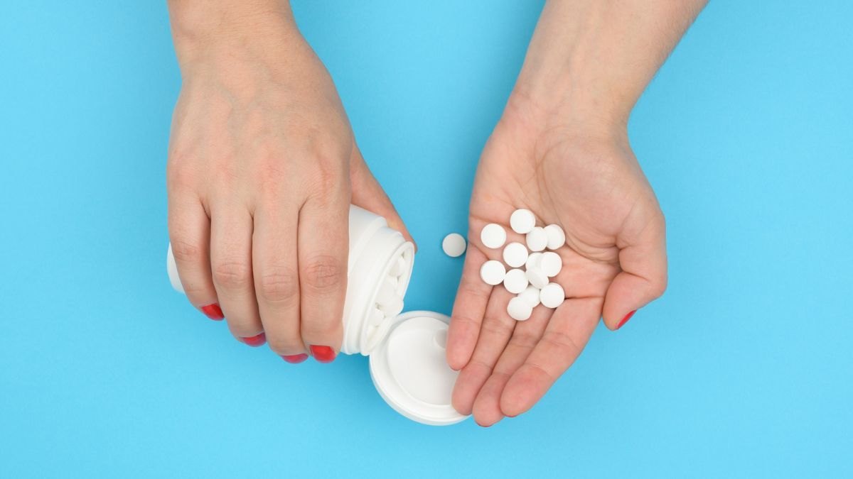 Close-up of a woman's hands holding pills