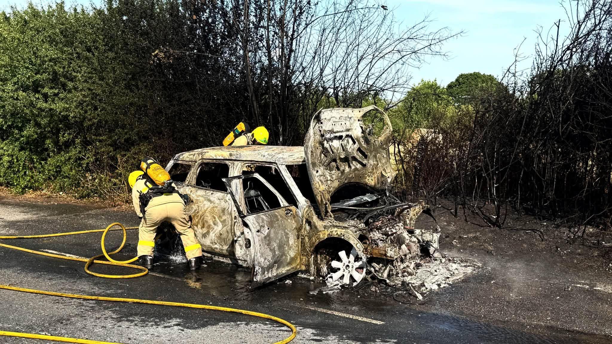 Fire destroys car and spreads to field
