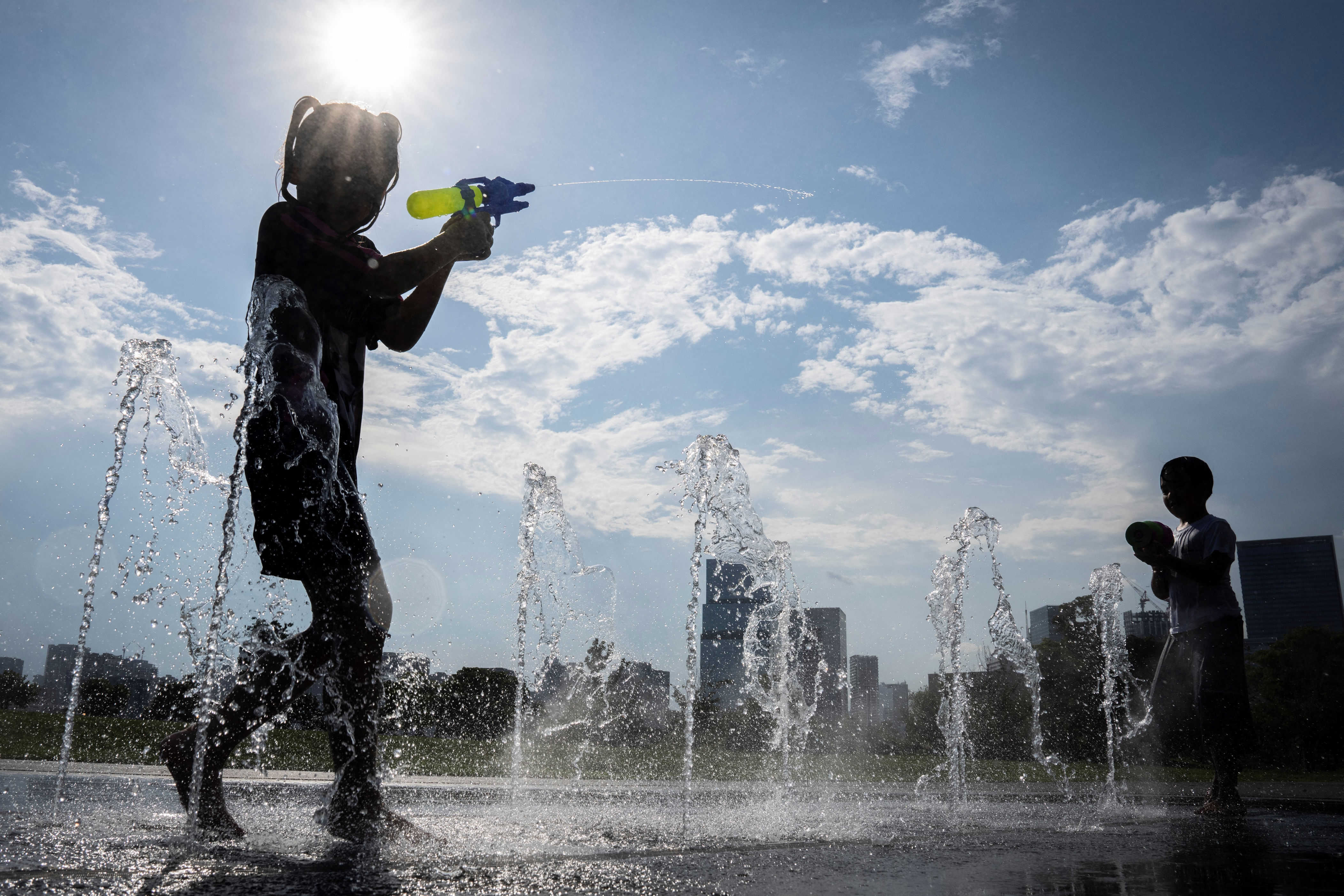 Children play in a water fountain at a park on a hot day in Tokyo (AFP/Getty)