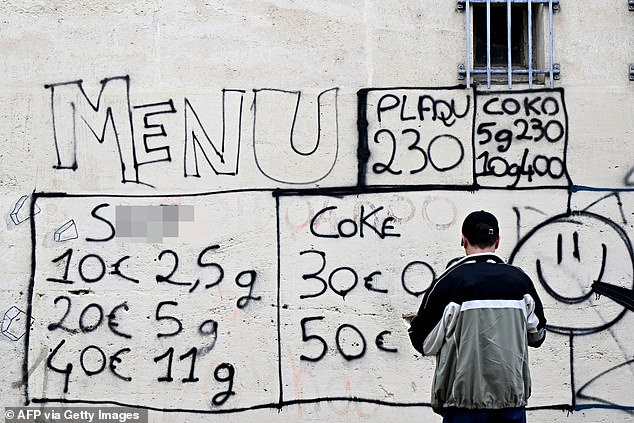 The 'menu' of different drugs sold by dealers is tagged on the facade of a building in a district of Avignon, south of France, on March 13, 2025