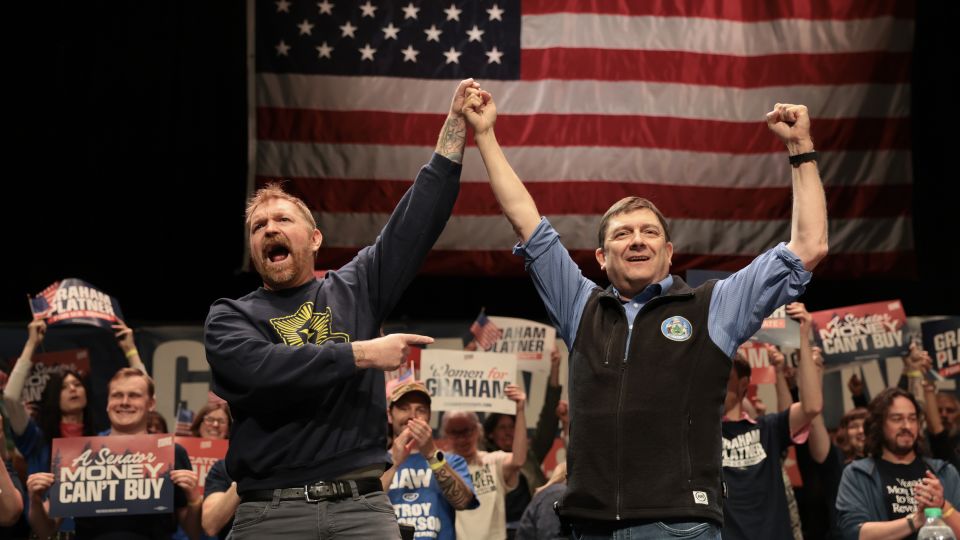 Graham Platner and Troy Jackson stand together during a “Fighting Oligarchy” tour stop at the Collins Center for the Arts on the University of Maine campus on May 24, 2026. - Joe Raedle/Getty Images