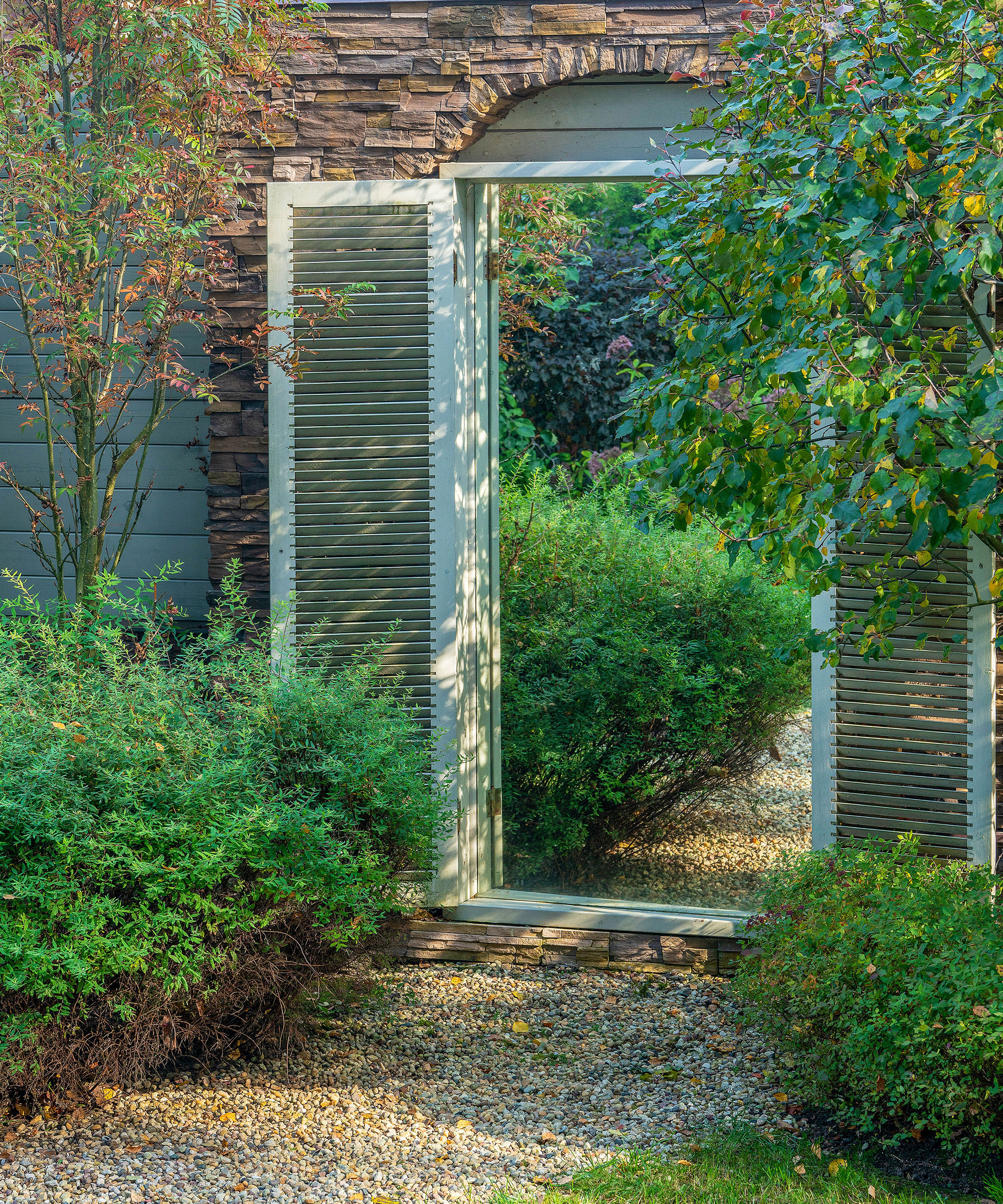 garden wall with mirror and planting