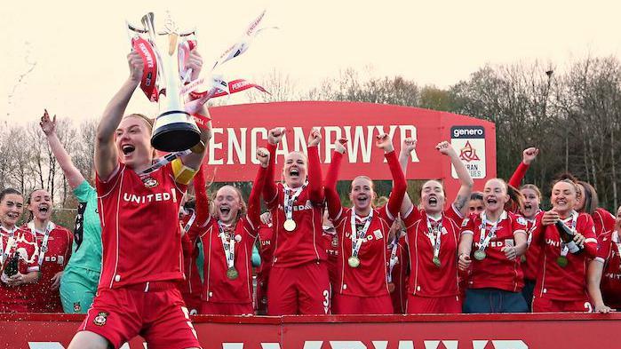 Wrexham captain Jodie Bartle lifts the Adran Premier Trophy in April