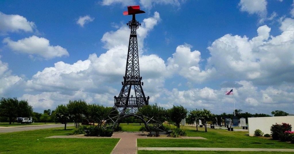 Views of a replica of the Eiffel Tower in Paris, Texas, with a large red cowboy hat on top, surrounded by greenery.
