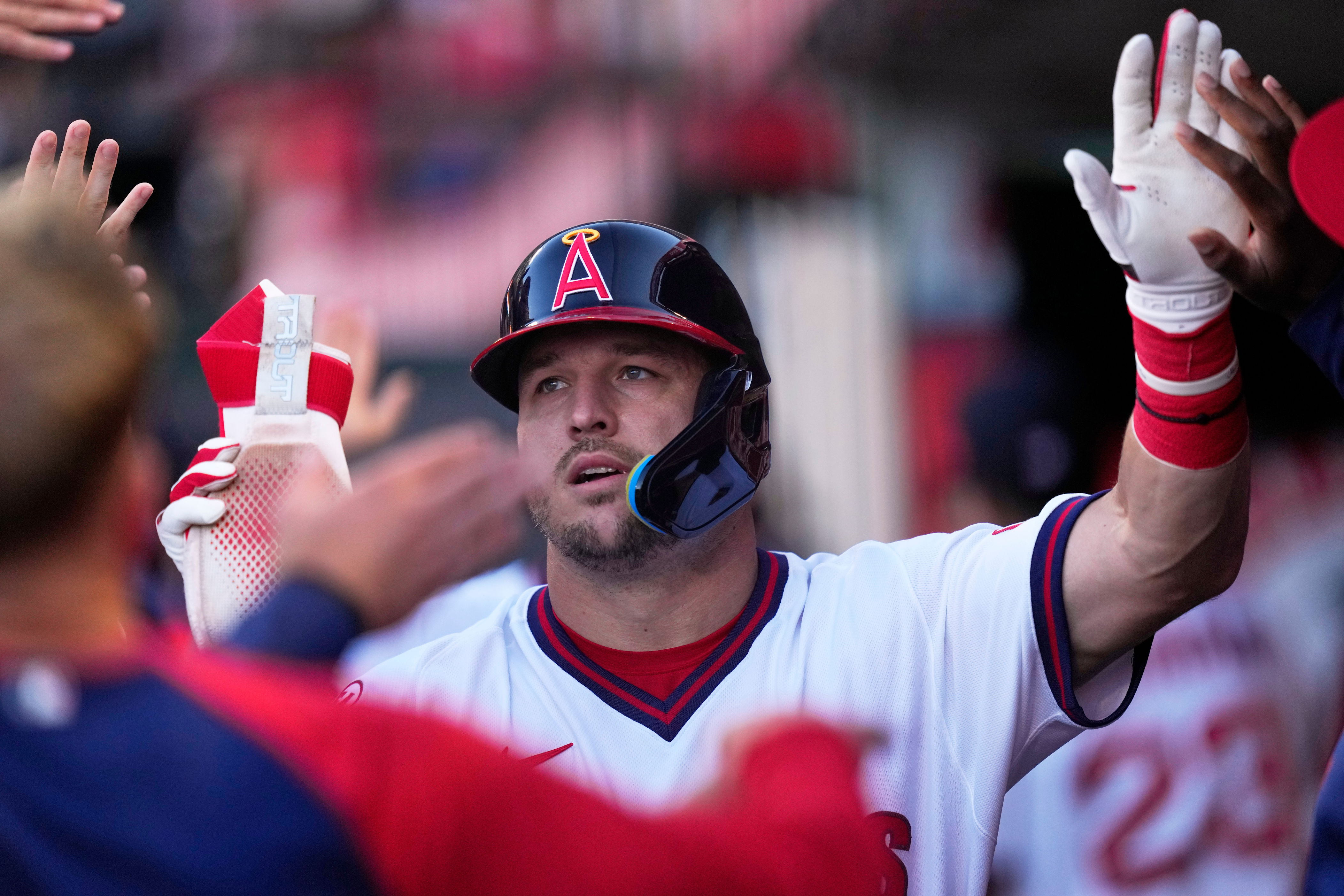 Los Angeles Angels' Mike Trout is congratulated by teammates in the dugout after scoring on a double by Jorge Soler during the first inning of a baseball game against the St. Louis Cardinals, Tuesday, July 21, 2026, in Anaheim, Calif. (AP Photo/Mark J. Terrill)