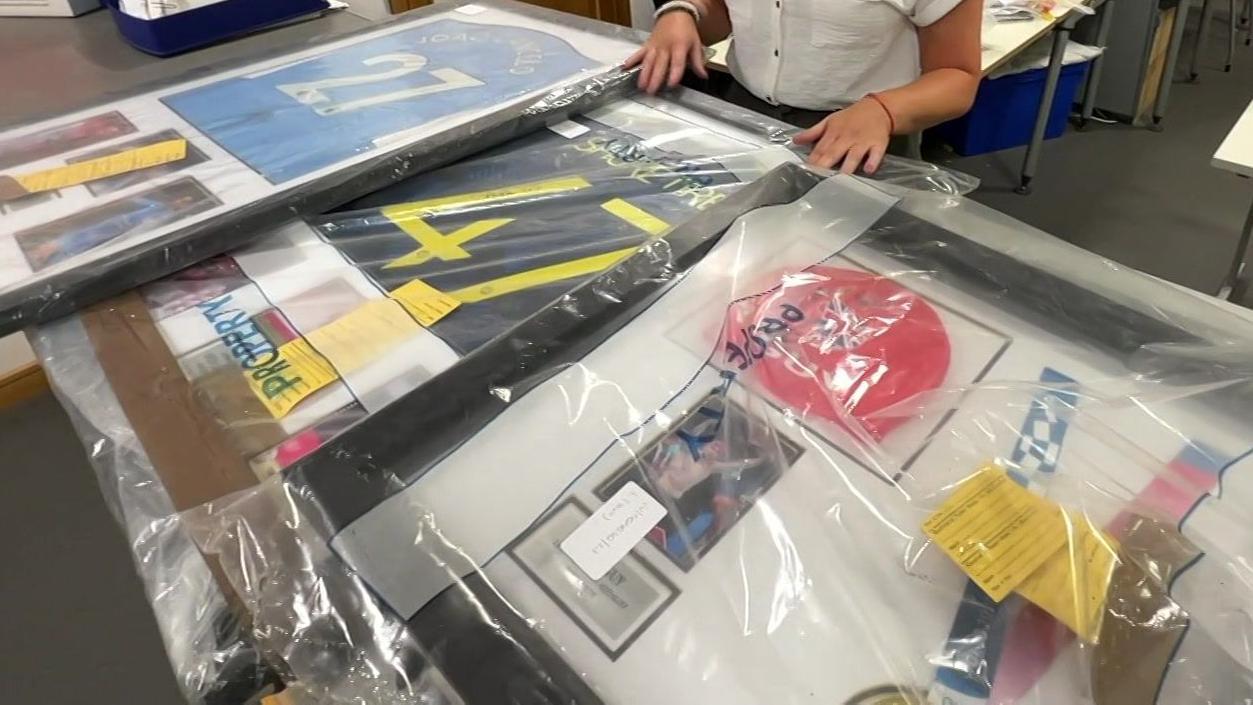 Signed and framed sporting memorabilia included a signed swimming cap and medal from Olympian James Guy