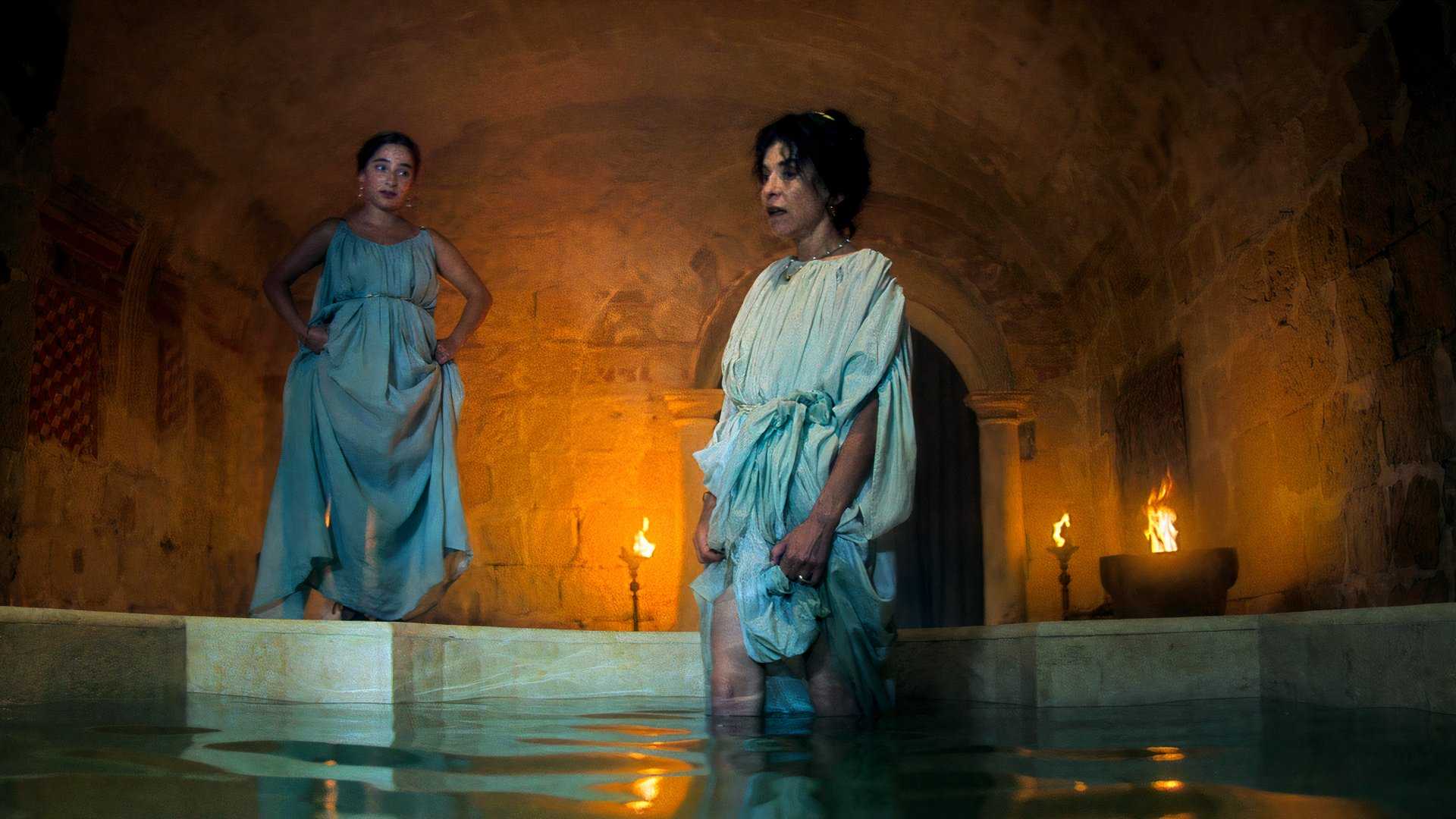 Two women stand in a tub in Pompeii Out of Time.