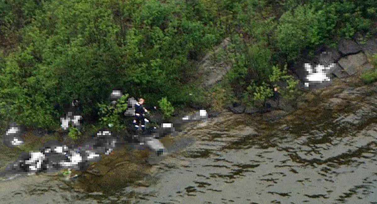 This image taken from a helicopter over Utoya. The gunman can be seen and bodies blurred.