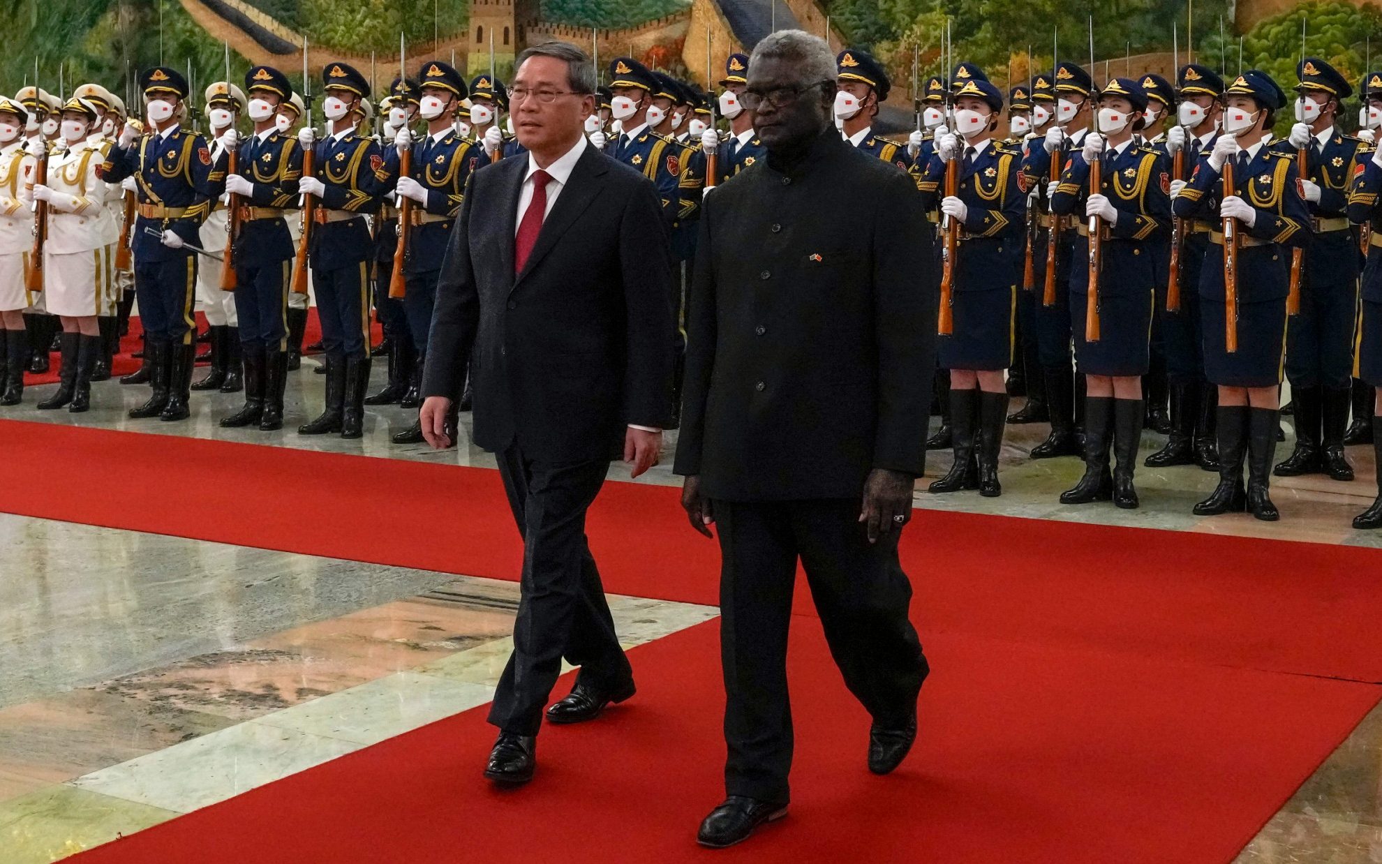 Solomon Islands' Prime Minister Manasseh Sogavare and China's Premier Li Qiang inspect the guard of honour during a welcome ceremony at the Great Hall of the People in Beijing on July 10, 2023
