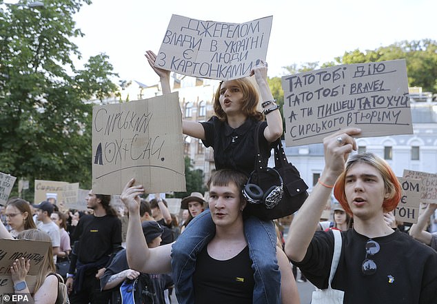 Ukrainians hold placards reading 'Fedorov is the defence minister', 'Don't mess with what works', 'Hands off Fedorov' and 'Bring Fedorov back'