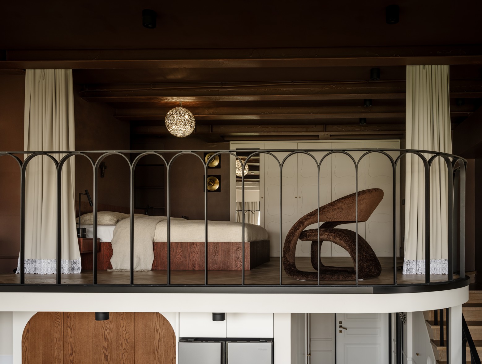 A bedroom with dark brown walls and ceiling