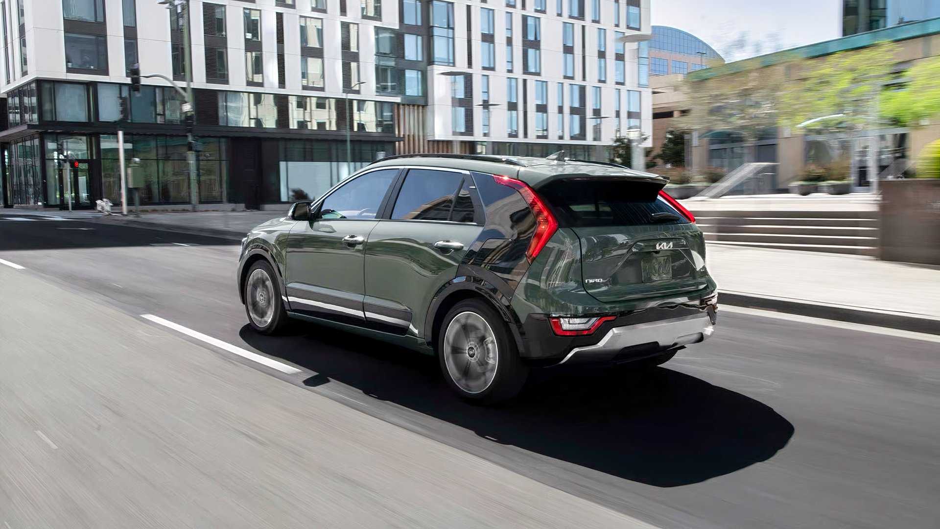 Rear 3/4 action shot of 2026 Kia Niro Hybrid driving on road