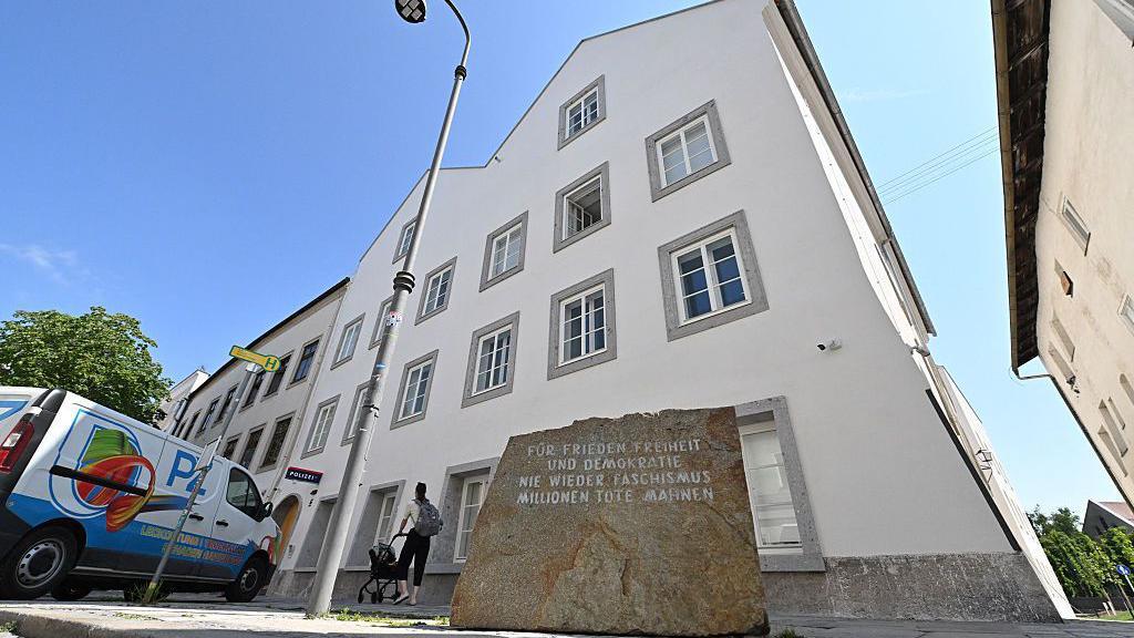 A memorial stone outside the building reads For Peace, Freedom and Democracy - Never Again Fascism - Millions of Dead Warn