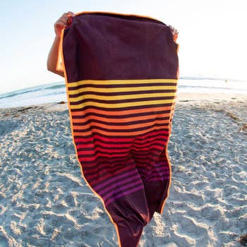 Person holding a striped beach towel