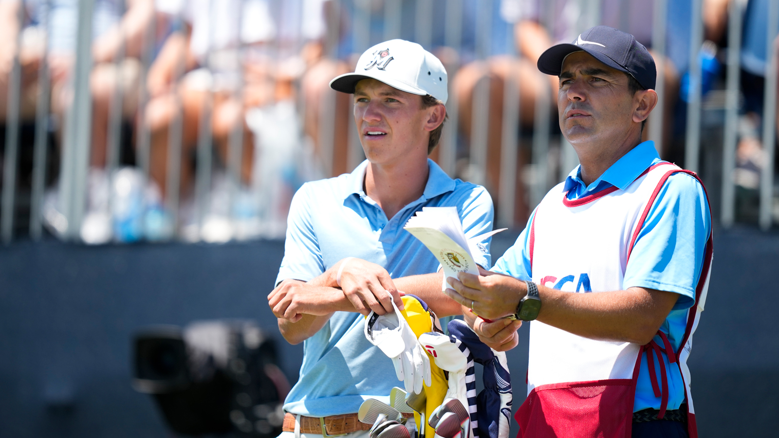 Miles Russell speaks to his caddie during the US Open