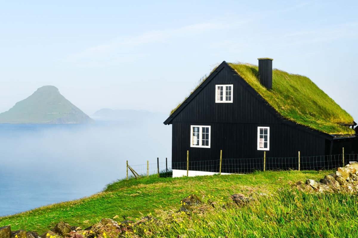 Cliffside-traditonal-sod-roofed-home-in-Faroe-Islands