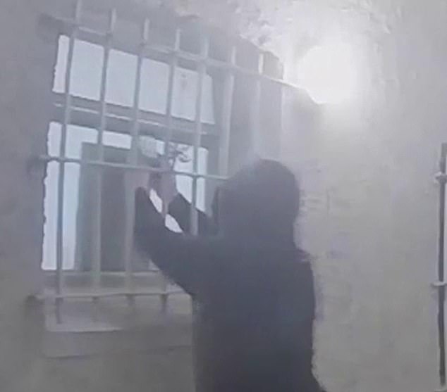 Durkan filming on a mobile phone through a window of one of his victims