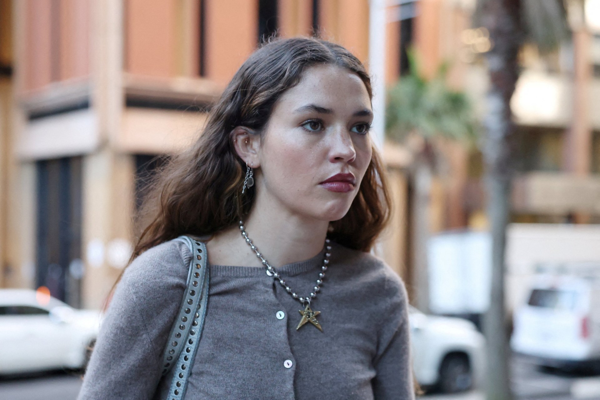 Charlotte MacInnes in brown jumper outside court