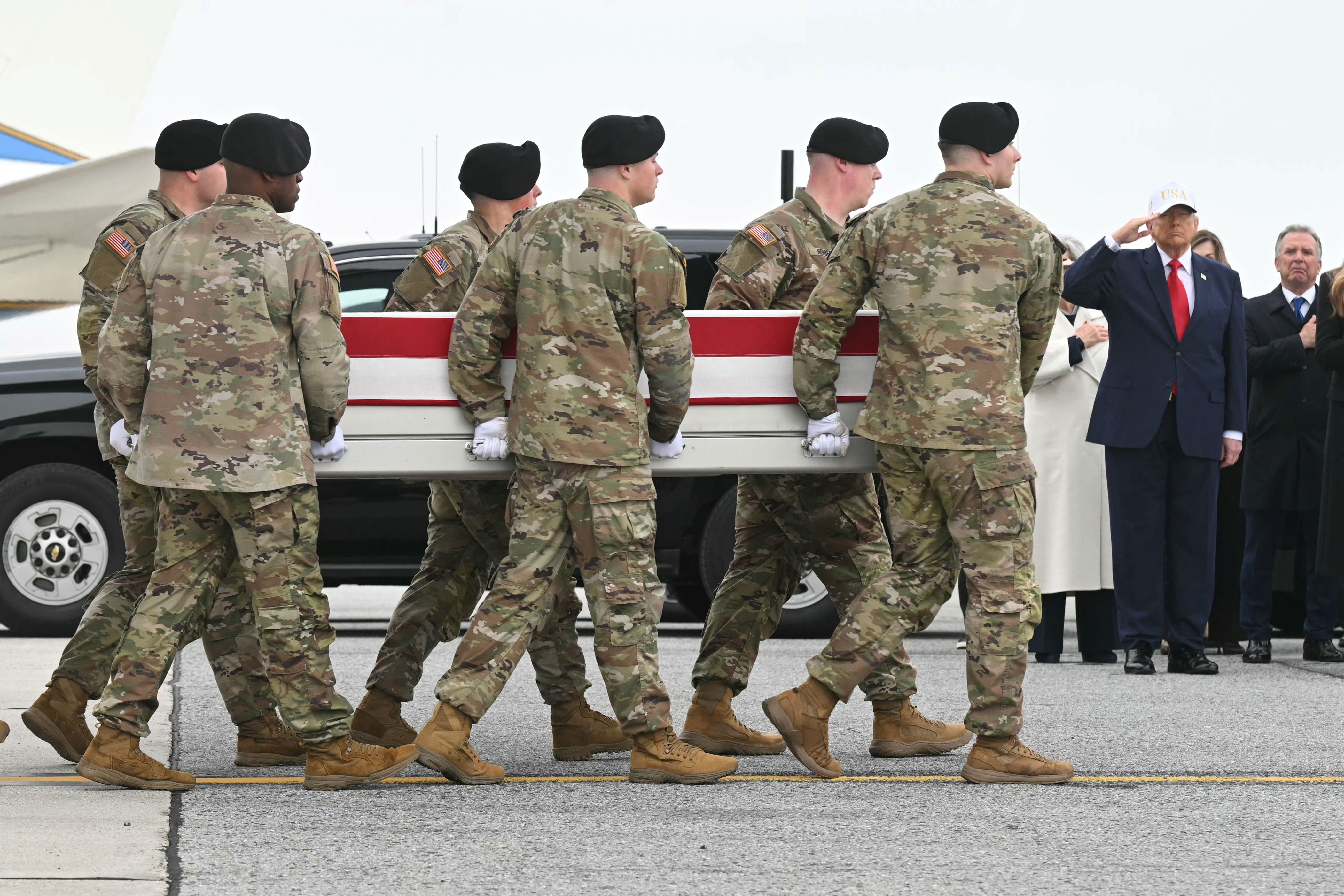 On Wednesday, Trump is set to attend the dignified transfer of the four service members who were recently killed in the Middle East. Pictured: Trump salutes as the remains of several soldiers are transferred at Dover Air Force Base on March 7 (AFP/Getty)