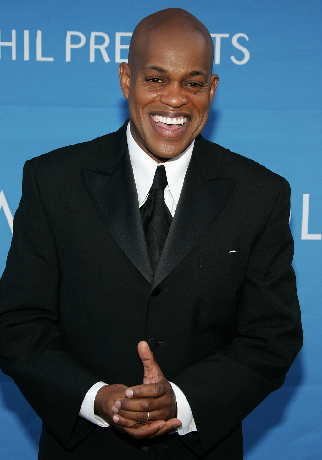 Jubilant Sykes smiling while wearing a tuxedo.