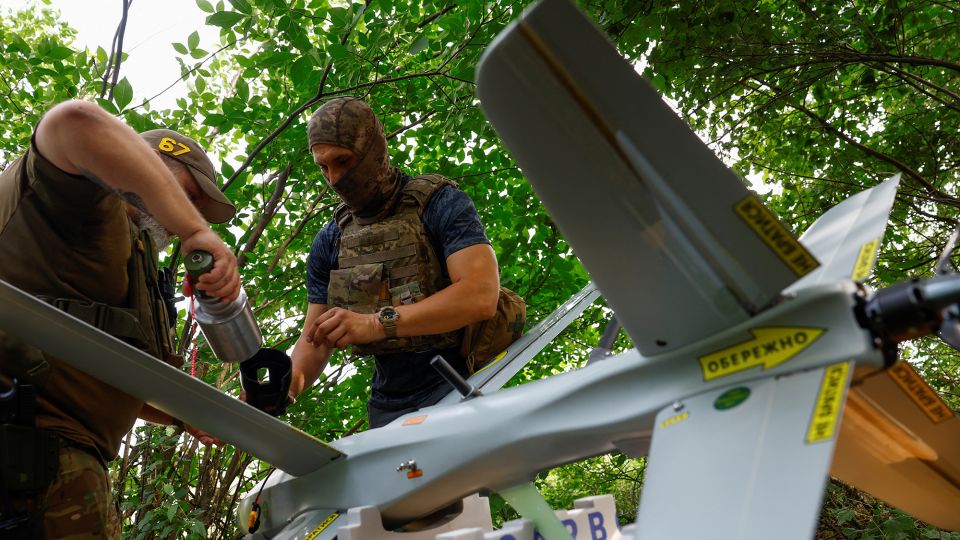 Service members of the 422nd Unmanned Systems Regiment prepare a strike drone for a flight in an undisclosed location in southern Ukraine. - Valentyn Ogirenko/Reuters