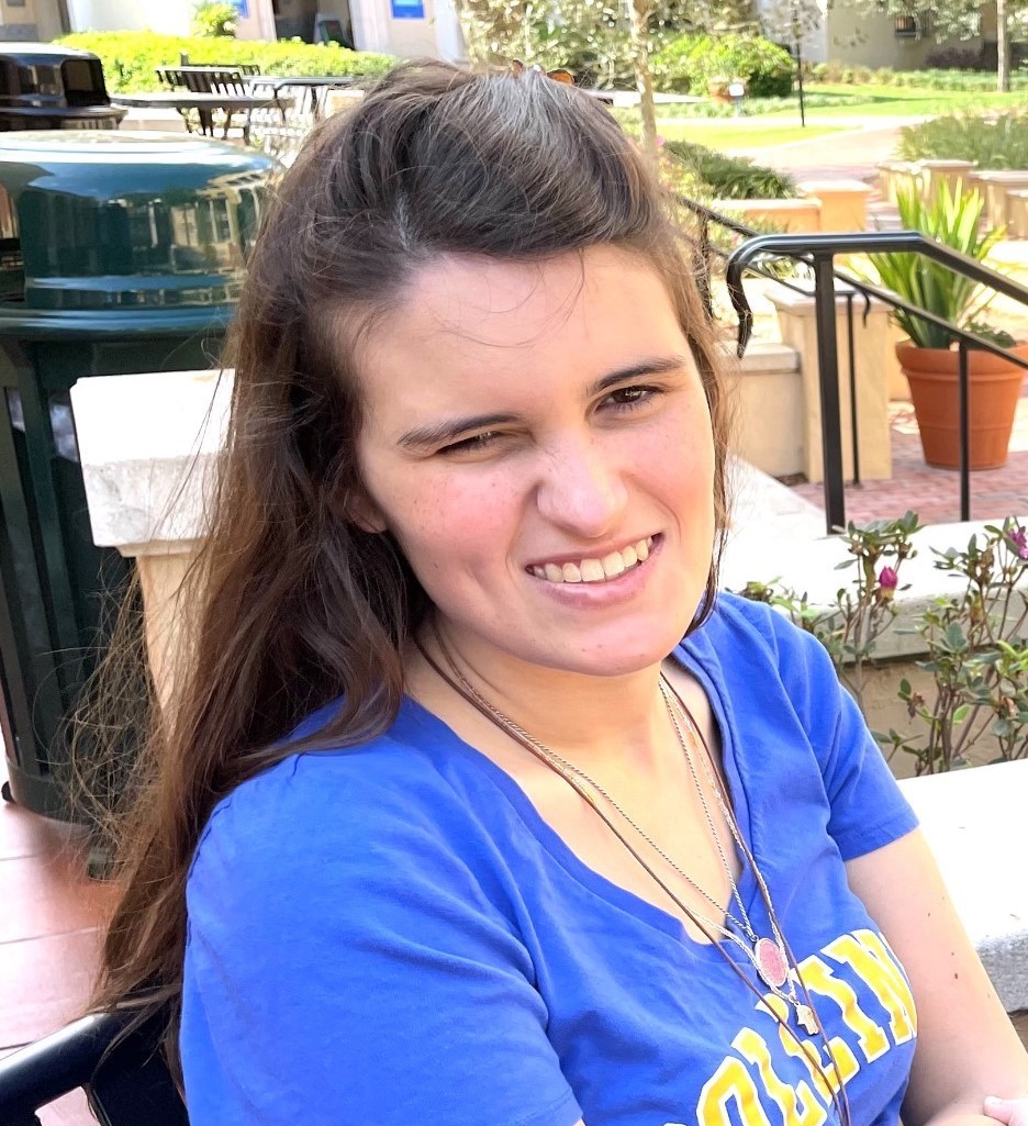 Elizabeth Bonker smiles while seated outdoors in a courtyard.