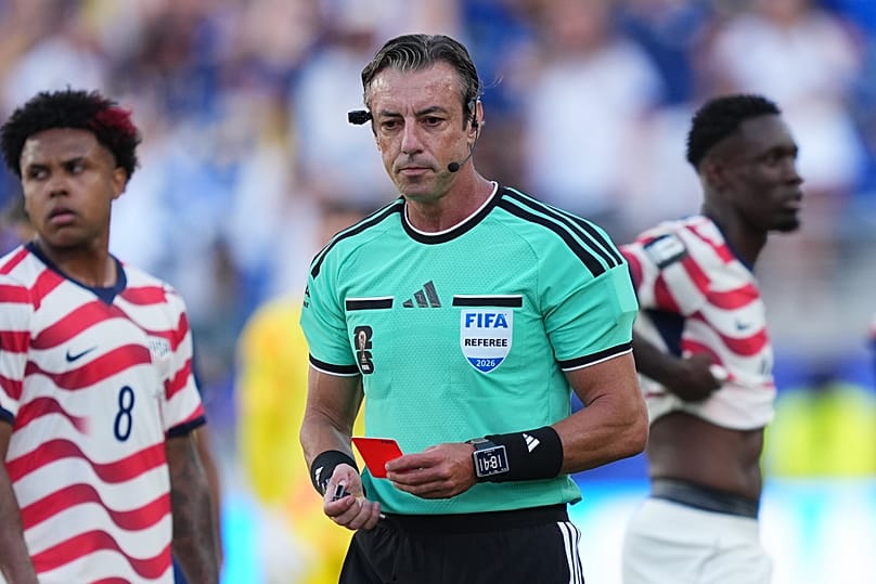 United States' Folarin Balogun, right, stands by after being issued a red card by Referee Raphael Claus.