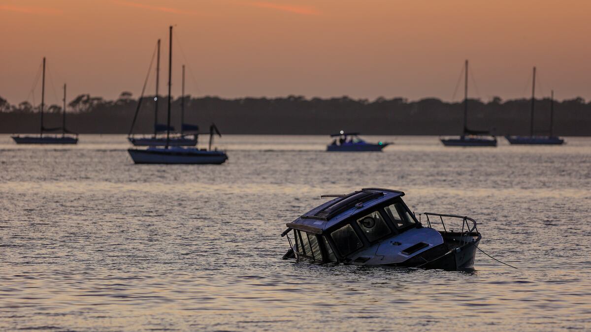 A derelict boat is seen partly sunk in the intracoastal waters just off the coast in this 2023 file photo in Dunedin. Farther to the south, a man in Key West has been cited more than 20 times for having derelict boats, and the state has paid more than $372,000 to have some of his vessels removed from the water. ©Chris Urso