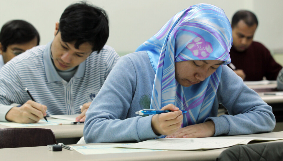 Foreigners solve exam questions in the Test of Proficiency in Korean (Topik) in an undated file photo.
