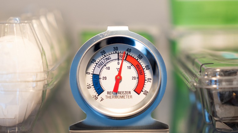 A refrigerator thermometer showing temperatures just below 40 degrees Fahrenheit.